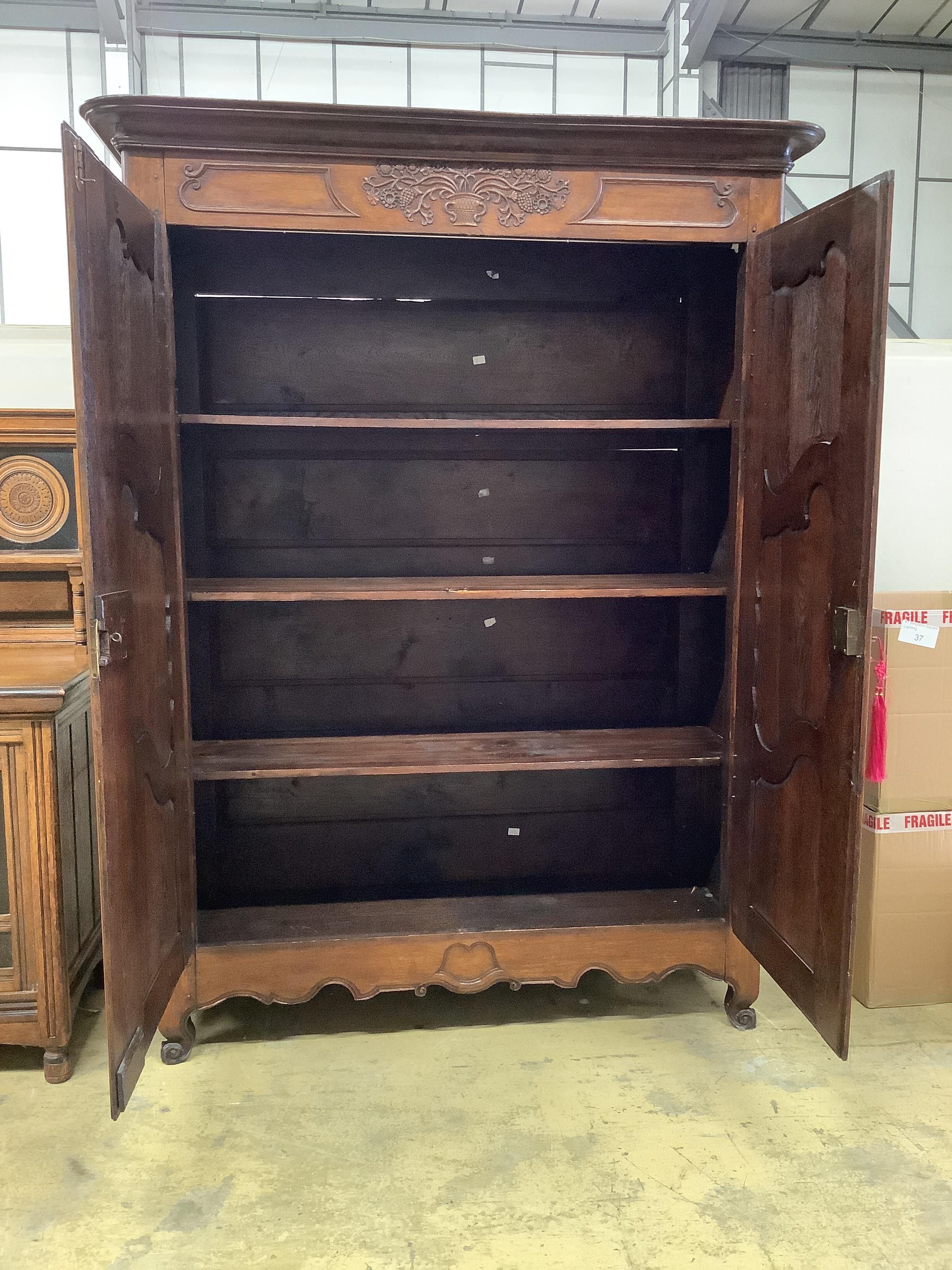 An 18th century French oak armoire, width 168cm, depth 62cm, height 216cm